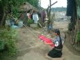 A young San Juan Chamula girl weaves cloth on a hand loom