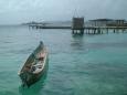 Canoe with a typical outhouse in background, Isla Nalunega