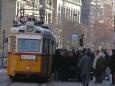 Morning commuters crowd a street tram