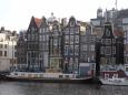 Row of ancient crooked buildings by the canal