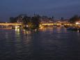 Evening lights twinkle on Ile de la Cite, the heart of Paris