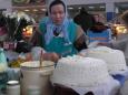 Old lady sells freshly made butter and cheese