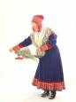 Lady in traditional Lappish dress decorates the chappel for a wedding